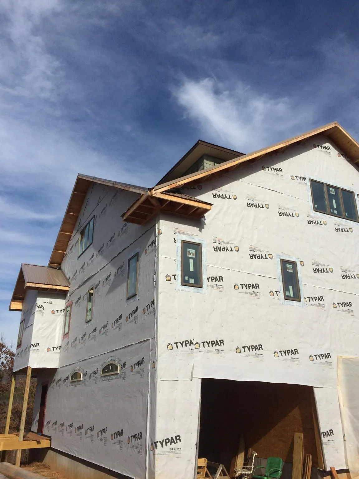 Stick built house wrapped in Typar with new roof framing and dormers in Thompson